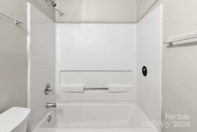 bathroom with toilet and shower / washtub combination