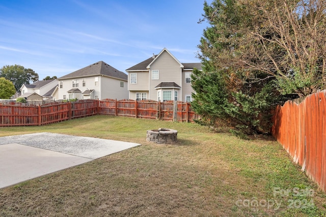 view of yard featuring a fire pit and a patio area