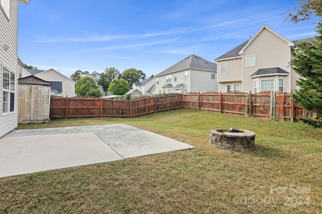 view of yard with an outdoor fire pit and a patio area