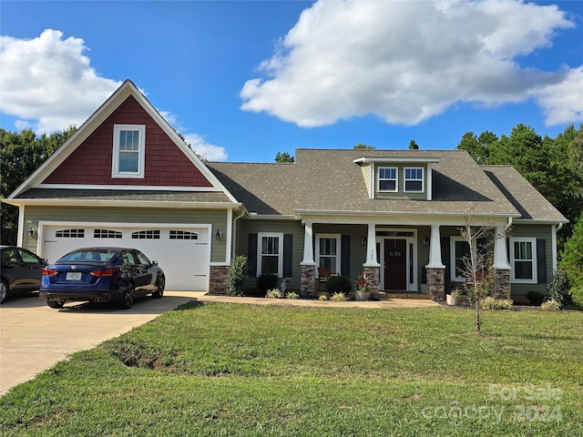 craftsman inspired home with a front yard, a garage, and a porch