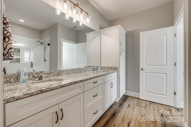 bathroom with vanity, hardwood / wood-style flooring, and walk in shower