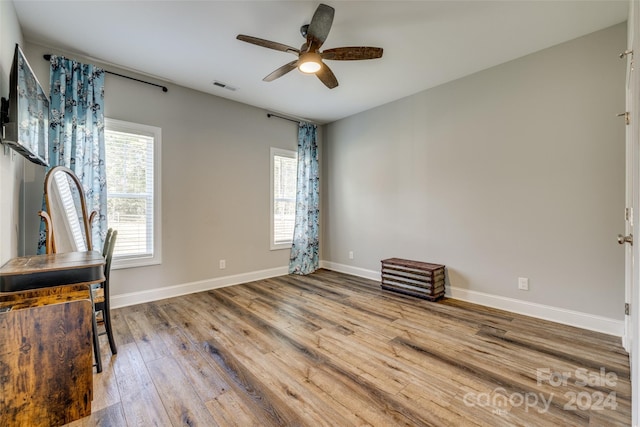 interior space featuring wood-type flooring and ceiling fan