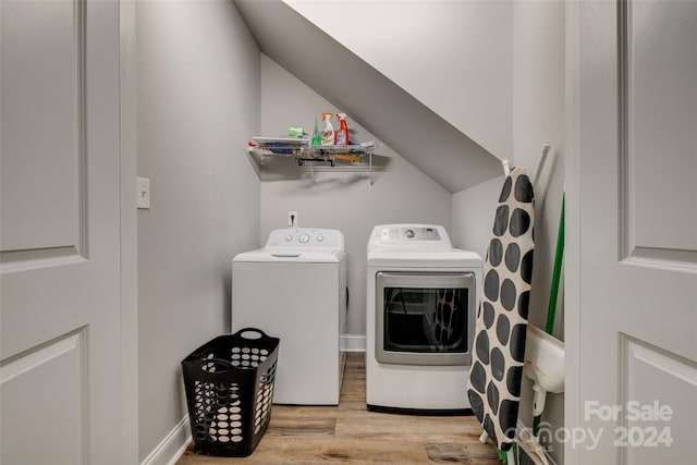 laundry room featuring light wood-type flooring and washing machine and clothes dryer