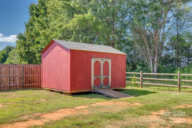 view of outbuilding with a lawn