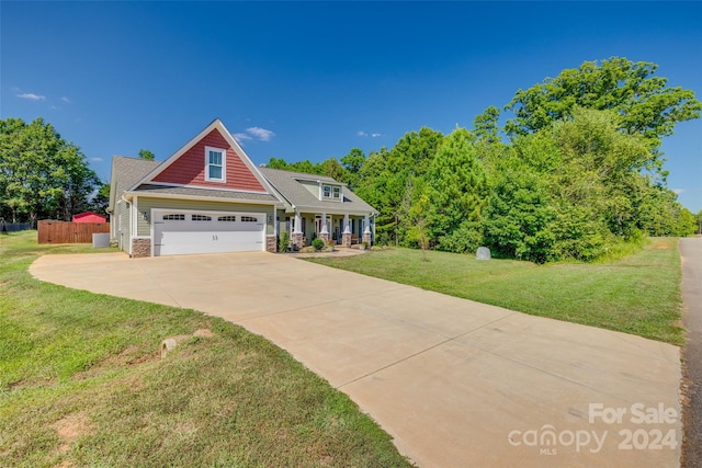 view of front of house featuring a garage and a front lawn