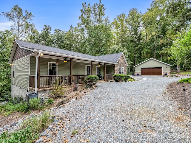 single story home featuring covered porch, an outdoor structure, and a garage