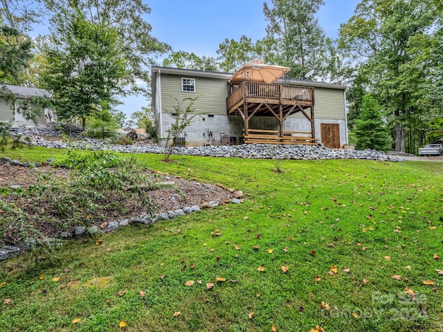 rear view of house with a yard and a deck