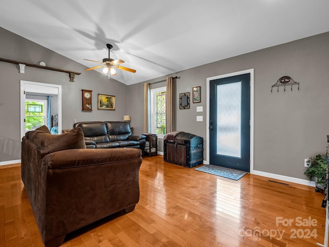 living room with hardwood / wood-style floors, ceiling fan, and vaulted ceiling