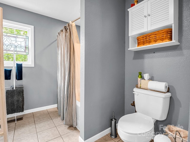 bathroom with tile patterned floors, toilet, and shower / bathtub combination with curtain