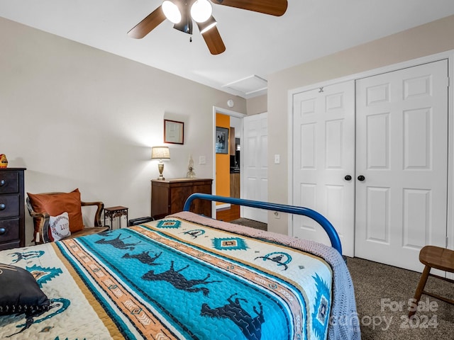 carpeted bedroom featuring a closet and ceiling fan