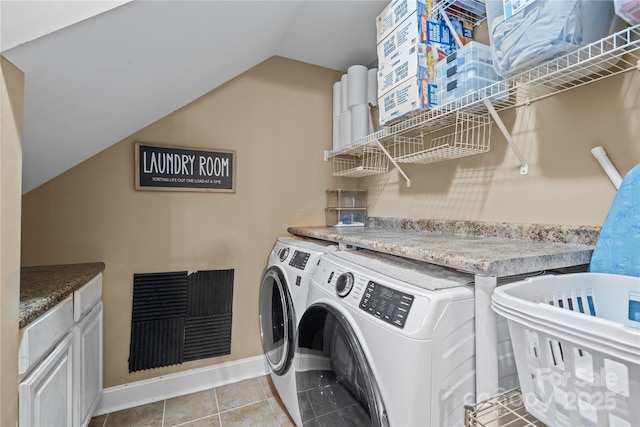 clothes washing area featuring light tile patterned flooring and washing machine and dryer