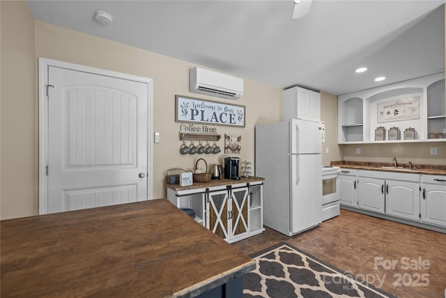 kitchen featuring white cabinetry, an AC wall unit, sink, and white appliances