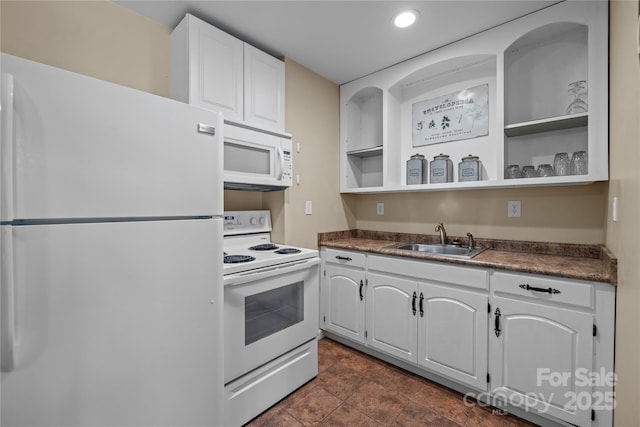 kitchen with sink, white appliances, and white cabinets