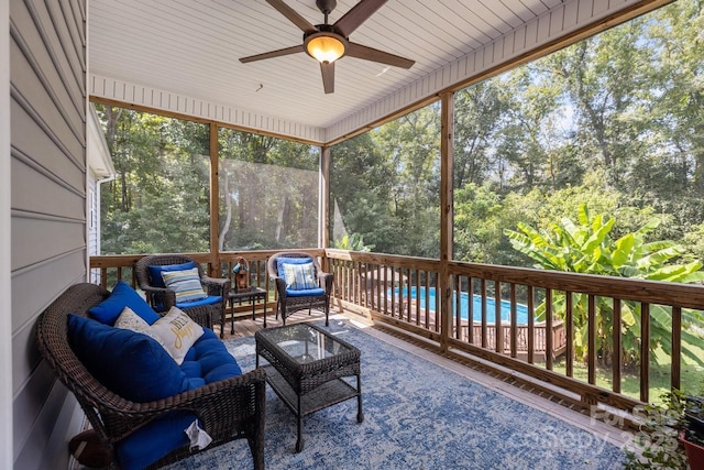 sunroom featuring ceiling fan