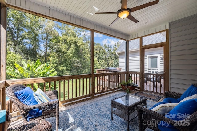 sunroom / solarium with a healthy amount of sunlight and ceiling fan