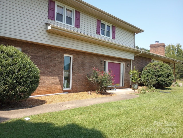 front facade with a front lawn