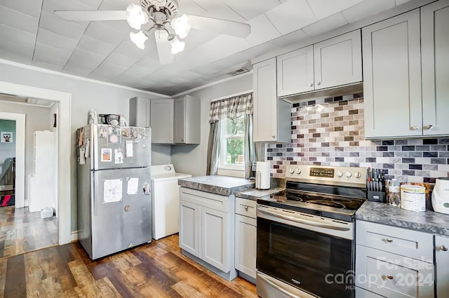 kitchen with crown molding, dark wood-type flooring, ceiling fan, washer / dryer, and appliances with stainless steel finishes