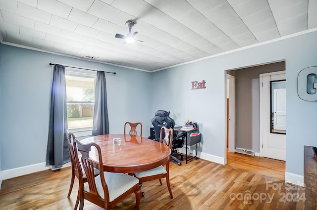 dining space featuring ornamental molding, wood-type flooring, and ceiling fan