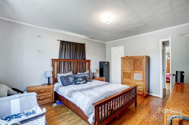 bedroom with wood-type flooring and ornamental molding