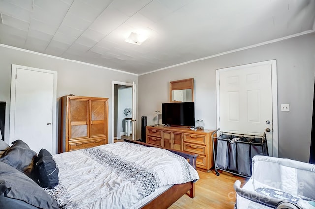 bedroom featuring light hardwood / wood-style floors and ornamental molding