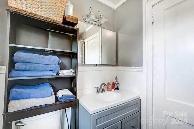 bathroom featuring vanity, toilet, and walk in shower