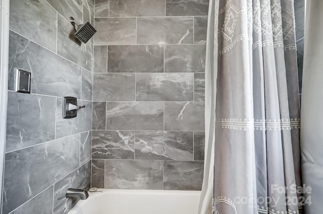 bathroom featuring shower / bath combo with shower curtain