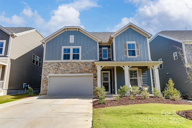 view of front facade with a front yard, a garage, and covered porch