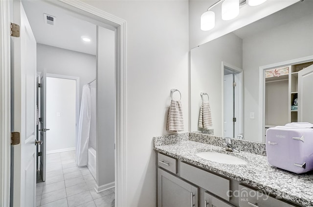 bathroom with tile patterned flooring, shower / tub combo with curtain, and vanity