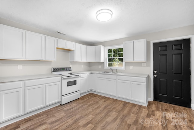 kitchen featuring light wood-type flooring, white cabinetry, sink, and white electric stove