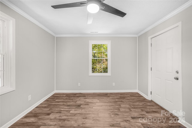 spare room with crown molding, hardwood / wood-style flooring, and ceiling fan