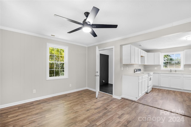 interior space with white electric range, ceiling fan, light wood-type flooring, and white cabinetry