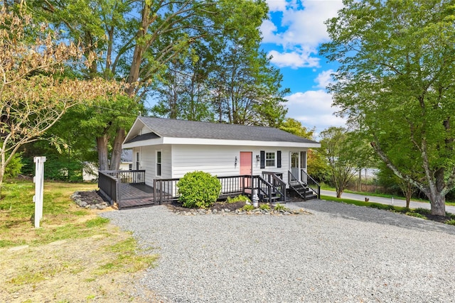 view of front facade with driveway and a wooden deck