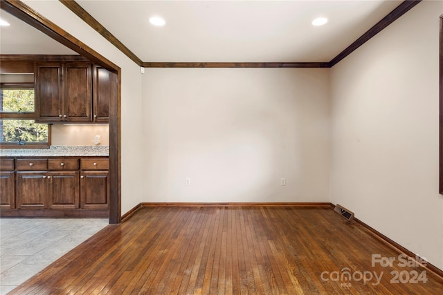 interior space with crown molding and dark wood-type flooring