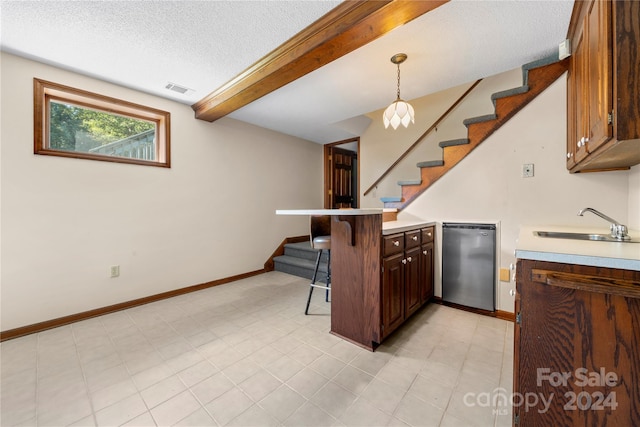 kitchen with a kitchen breakfast bar, stainless steel dishwasher, kitchen peninsula, pendant lighting, and a textured ceiling