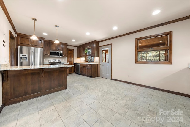 kitchen with a breakfast bar, appliances with stainless steel finishes, decorative light fixtures, light stone counters, and kitchen peninsula