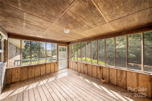 unfurnished sunroom featuring wooden ceiling