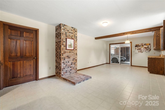 entryway with a textured ceiling and baseboards