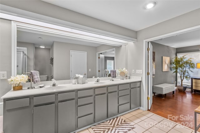 bathroom featuring vanity, hardwood / wood-style flooring, and a healthy amount of sunlight