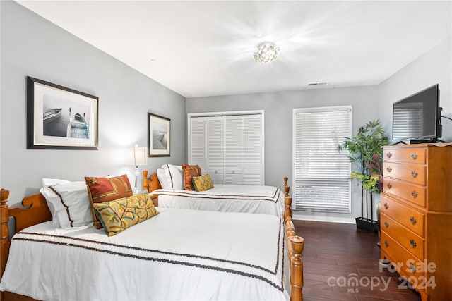 bedroom with a closet and dark hardwood / wood-style flooring