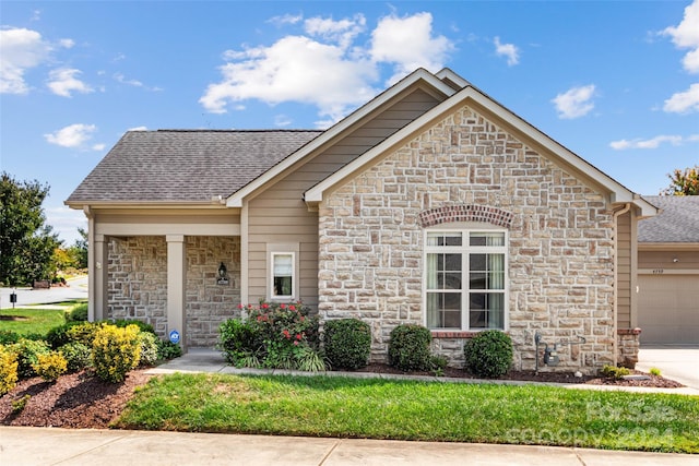 4759 Polo Gate Blvd, Charlotte, NC 28216 - view of front of home featuring stone siding, driveway, a garage, and roof with shingles