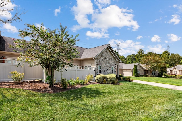 view of front of property featuring a garage and a front lawn