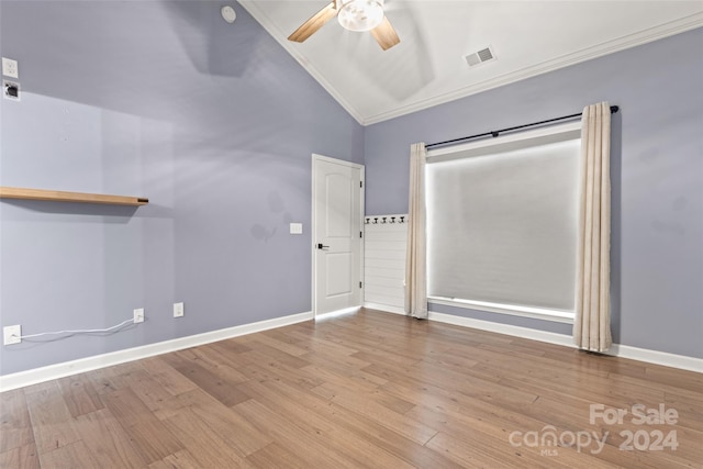 spare room with ornamental molding, light hardwood / wood-style floors, ceiling fan, and vaulted ceiling