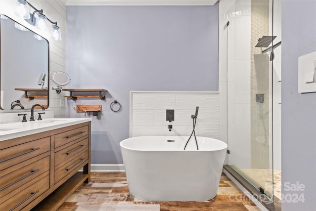 bathroom with independent shower and bath, vanity, and wood-type flooring