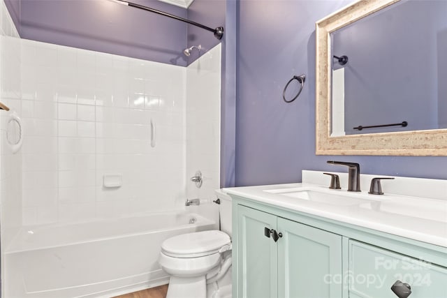 full bathroom with vanity, hardwood / wood-style flooring, shower / washtub combination, and toilet