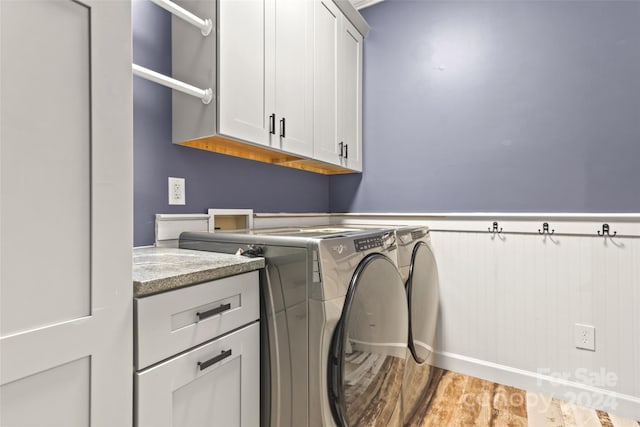 washroom featuring cabinets and independent washer and dryer