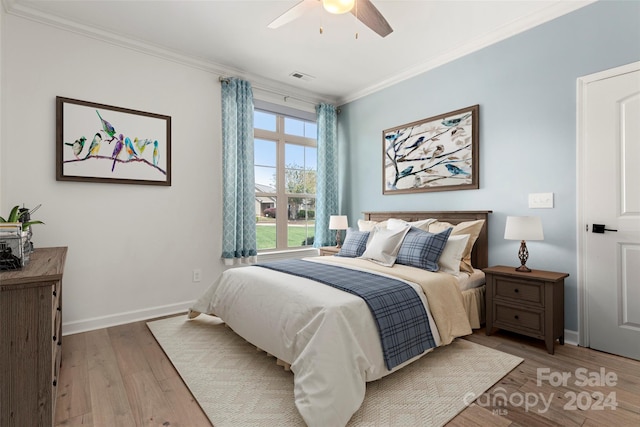 bedroom with light hardwood / wood-style floors, ceiling fan, and ornamental molding