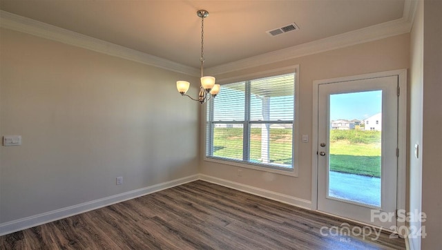 entryway with crown molding, dark hardwood / wood-style flooring, and a notable chandelier