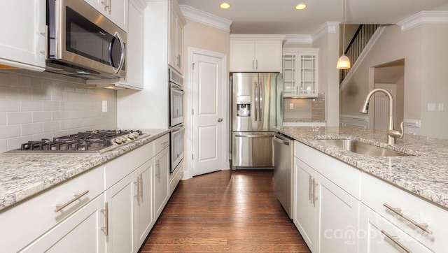 kitchen with white cabinets, appliances with stainless steel finishes, sink, and dark wood-type flooring