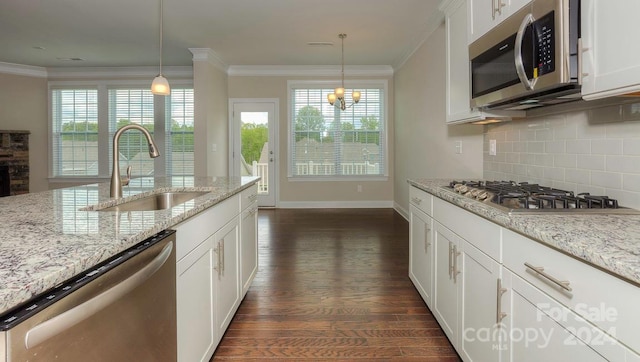 kitchen featuring white cabinetry, stainless steel appliances, sink, hanging light fixtures, and dark hardwood / wood-style floors