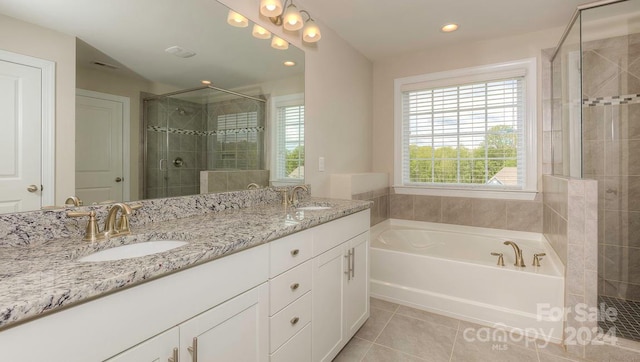 bathroom featuring shower with separate bathtub, vanity, and tile patterned floors